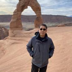 Dr Duan in Arches National Park wearing a grey jacket